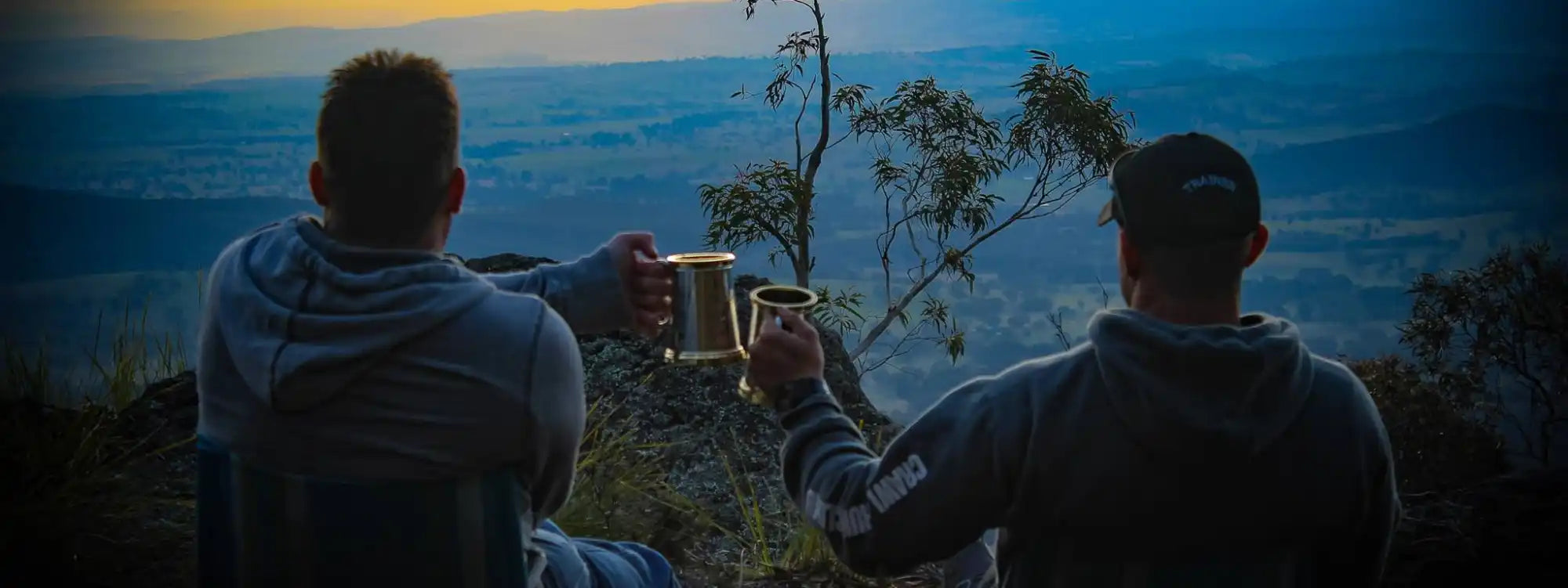 Two men toasting with mugs.