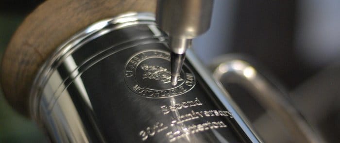 A tankard being engraved with a personalised message